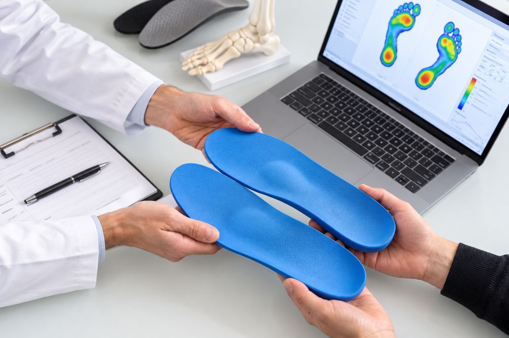 Custom insole design consultation at computer